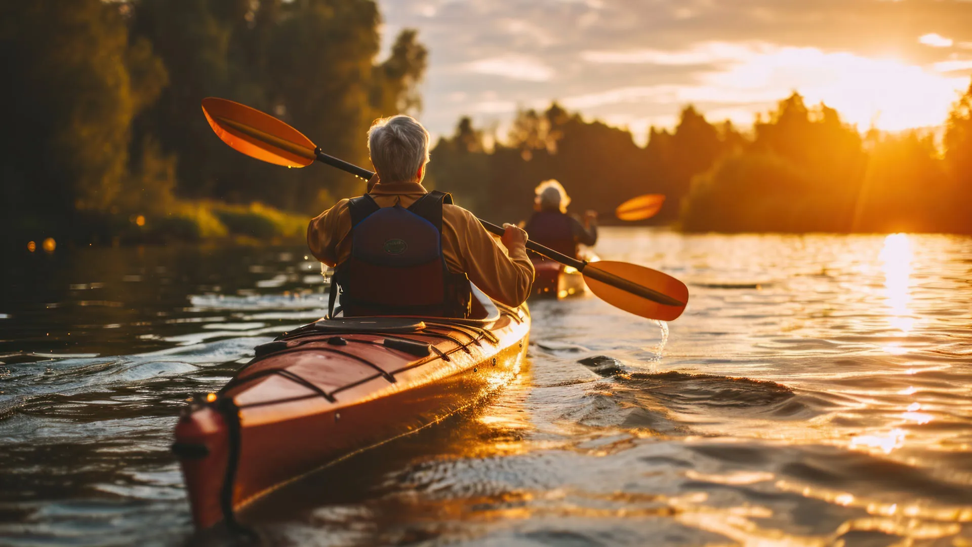 Senior Couple Kayaking on the Lake Together at Sunset